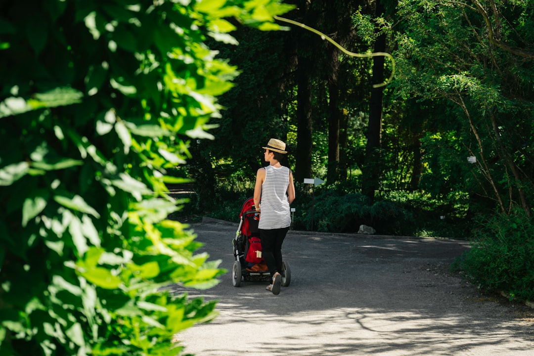 Šeima vaikšto parke su kūdikio vežimėliu